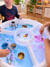 Children playing with glowing colour changing sensory light tables