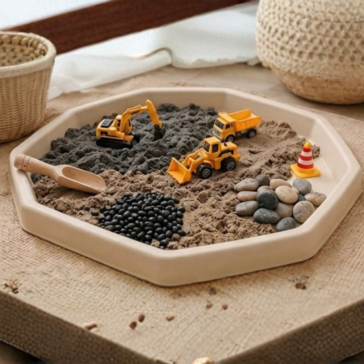 Tuff Tray ,Beige Colour, sensory play tray filled with toy construction vehicles and stones.