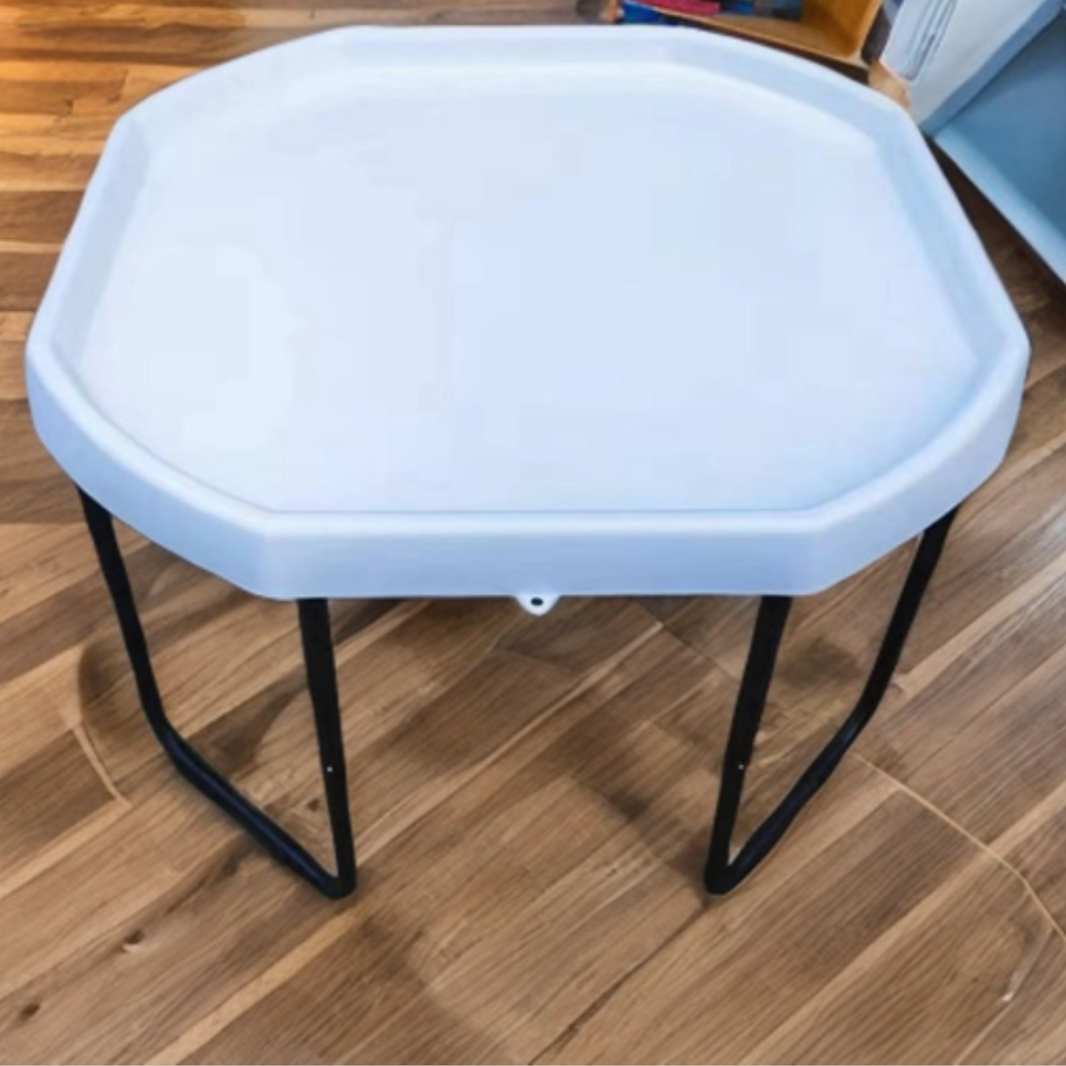 A tuff tray stand, photographed on a wood floor.