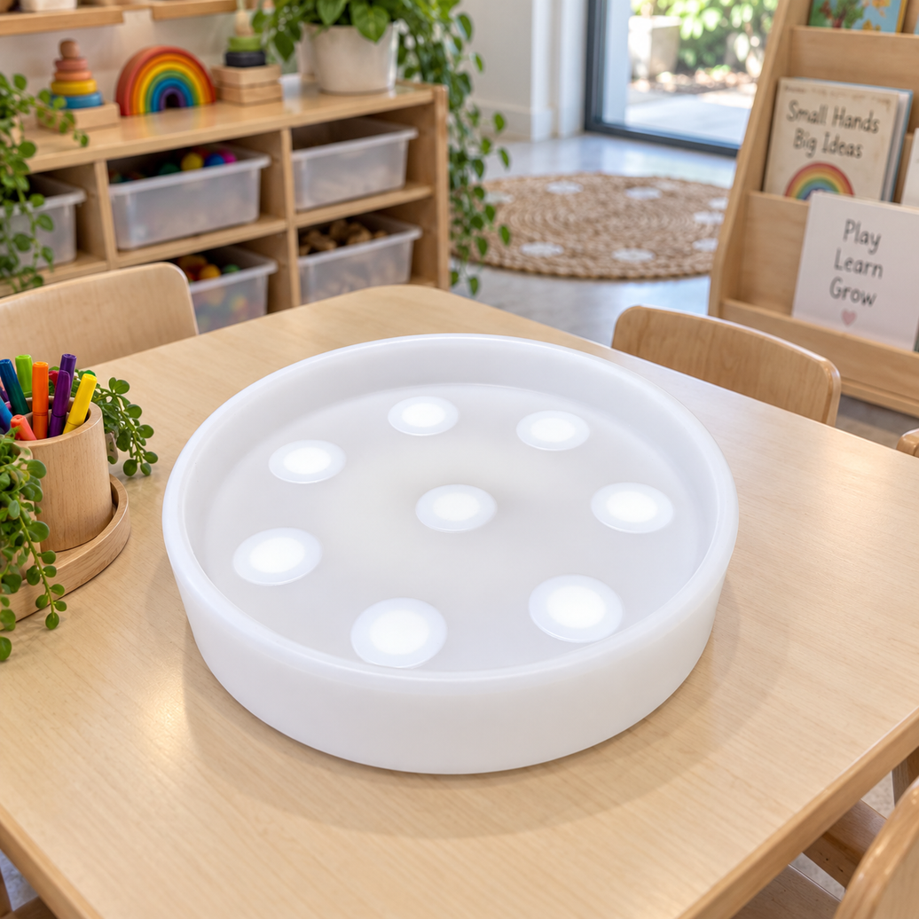 Tabletop Sensory Light Play tray on a classroom table, showing the eight raised touch domes that change colour when pressed