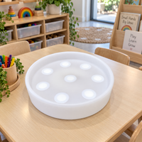Tabletop Sensory Light Play tray on a classroom table, showing the eight raised touch domes that change colour when pressed